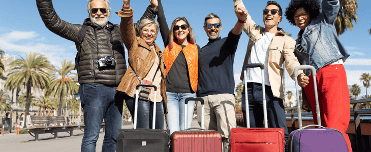 travelers smiling with suitcase.